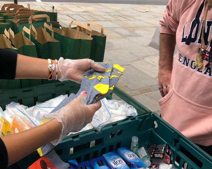Giving out socks and essentials to people experiencing homelessness during a volunteering session