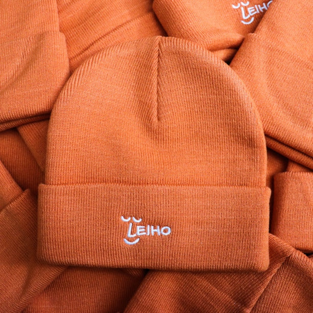 Give the gift of warmth this autumn in our smiley orange beanie!